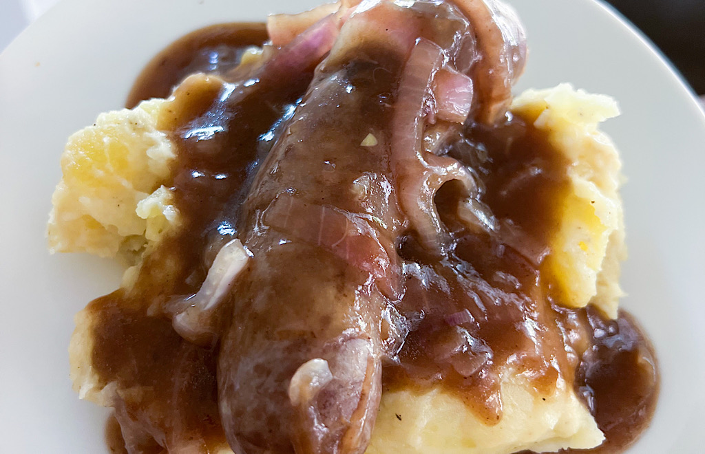 Sausage with gravy on mashed potatoes