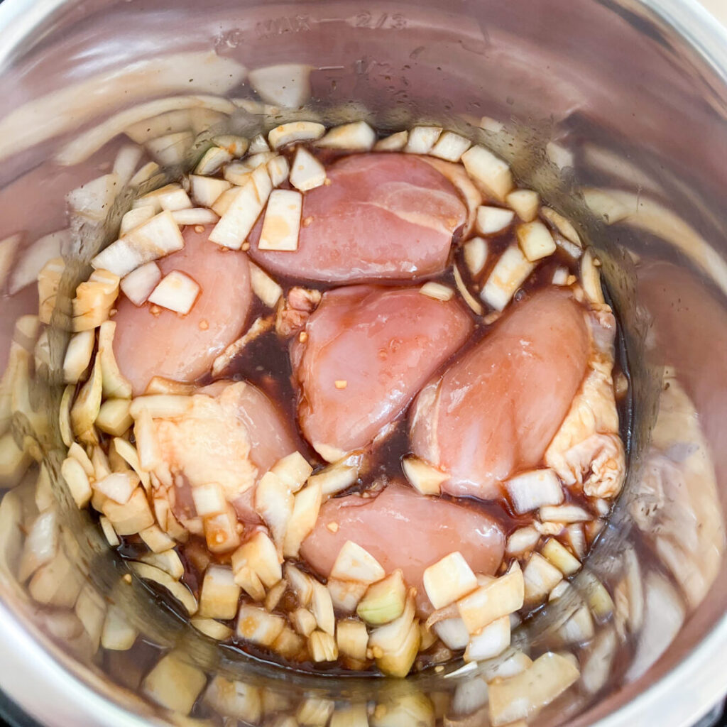 Instant Pot with chicken thighs and bourbon chicken mixture