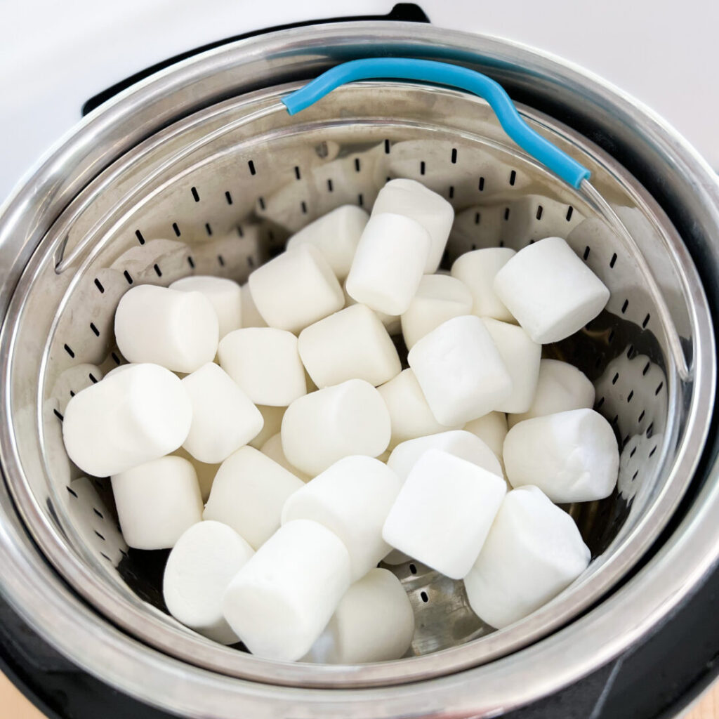 Marshmallows inside a steamer basket in an Instant Pot