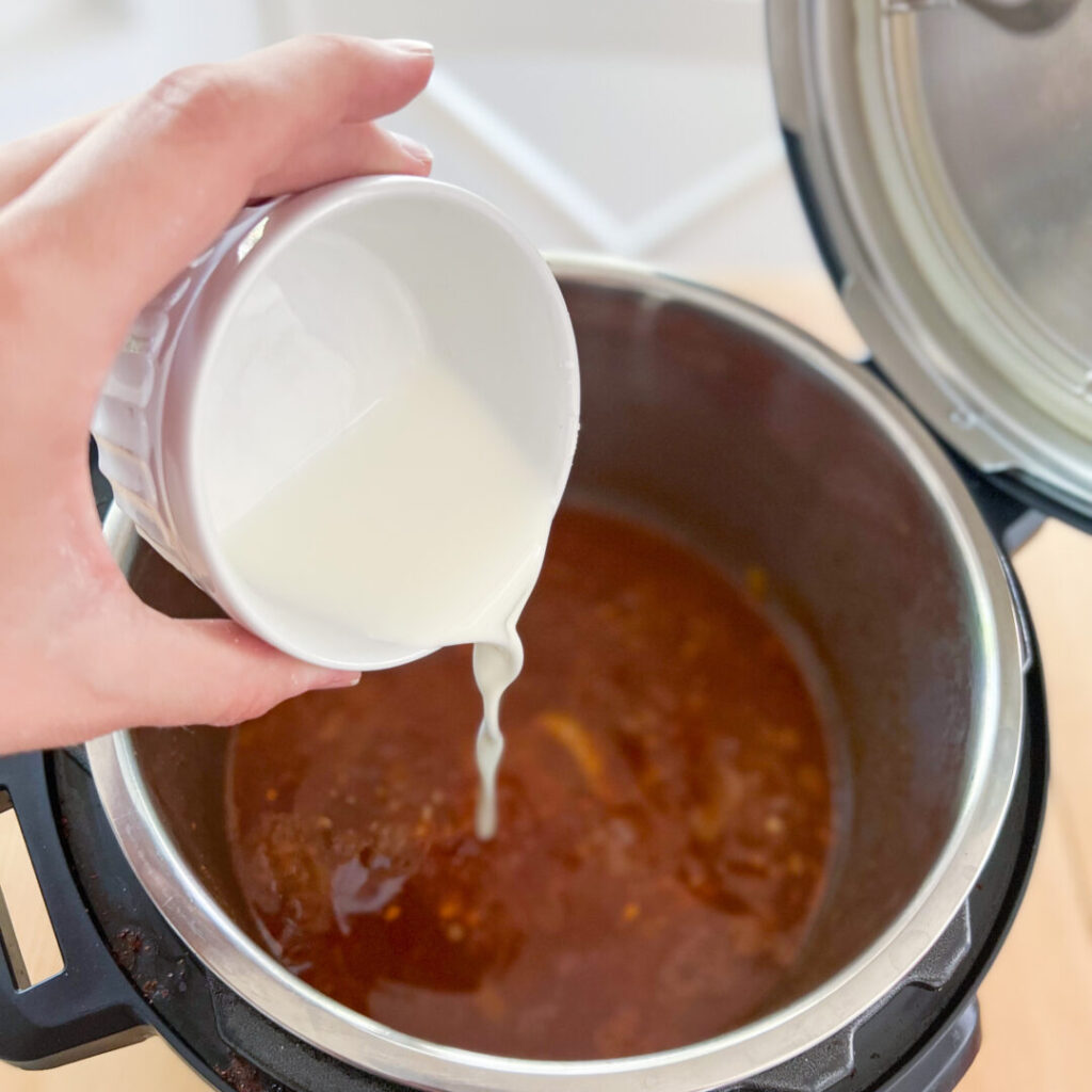 Pouring cornstarch slurry into the Instant Pot
