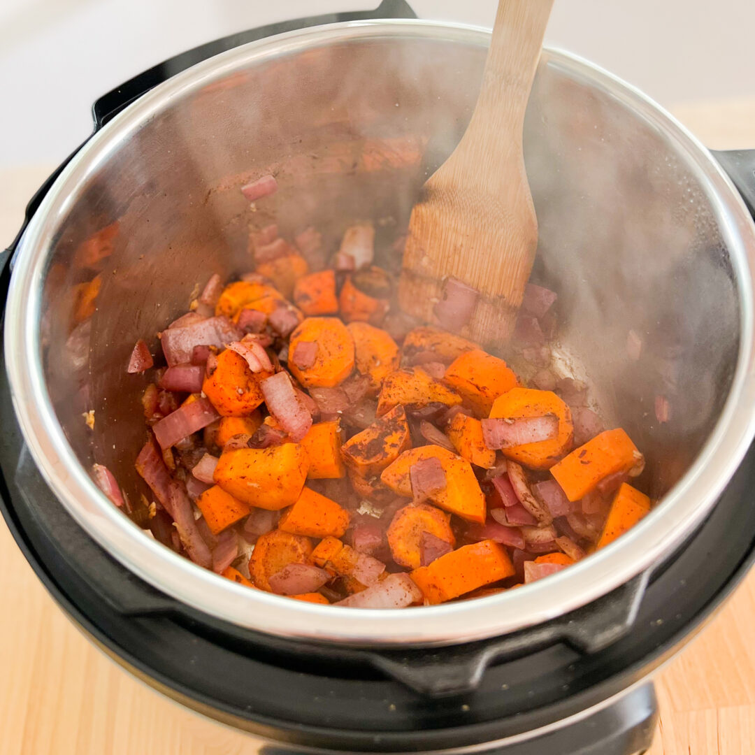 Carrots red onion and spices sautéing in an Instant Pot