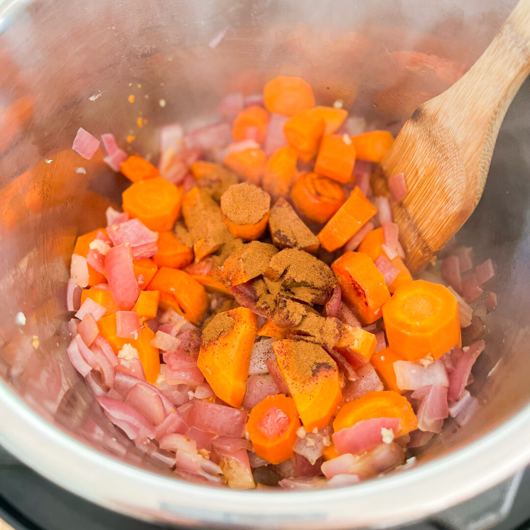 Cinnamon on carrots and red onion in an Instant Pot