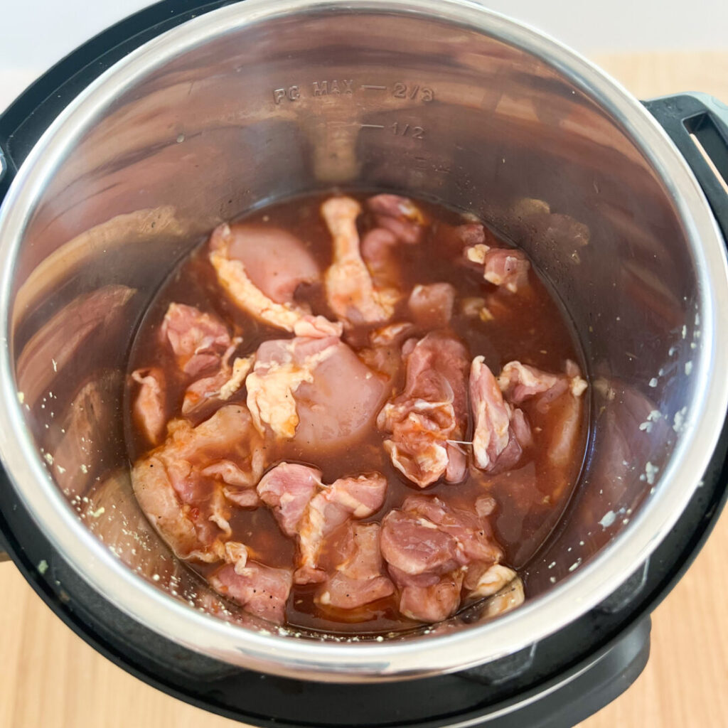 Chicken thighs in an Instant Pot with sauce.