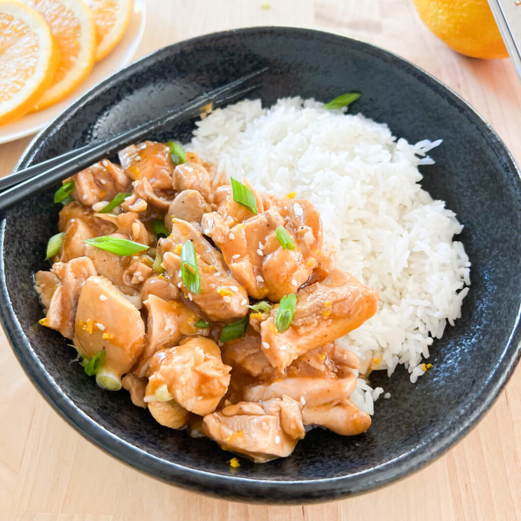Instant Pot orange chicken plated with rice.