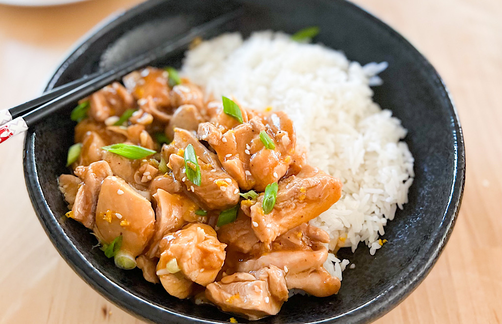Instant Pot orange chicken plated with rice.