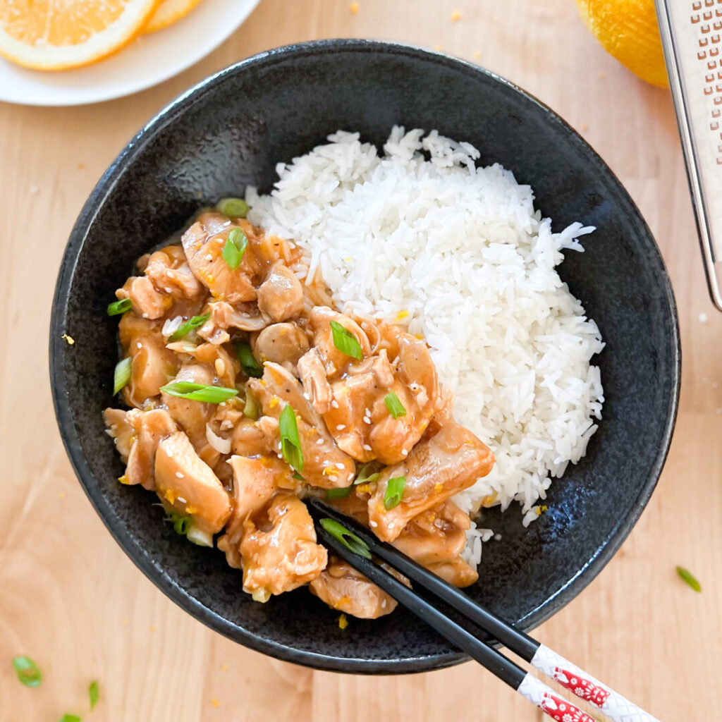 Instant Pot orange chicken plated with rice.
