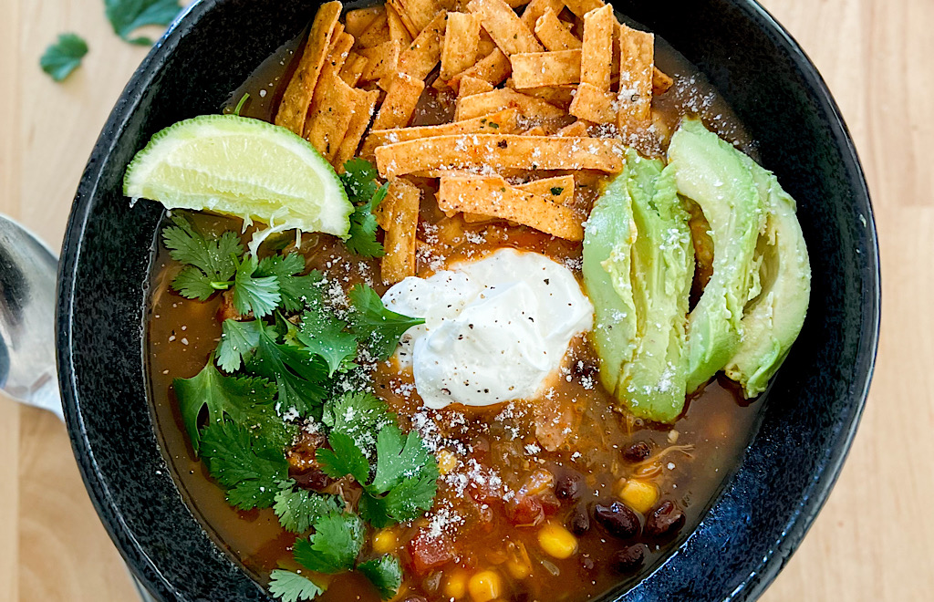 Instant Pot Chicken Tortilla Soup in a black bowl.