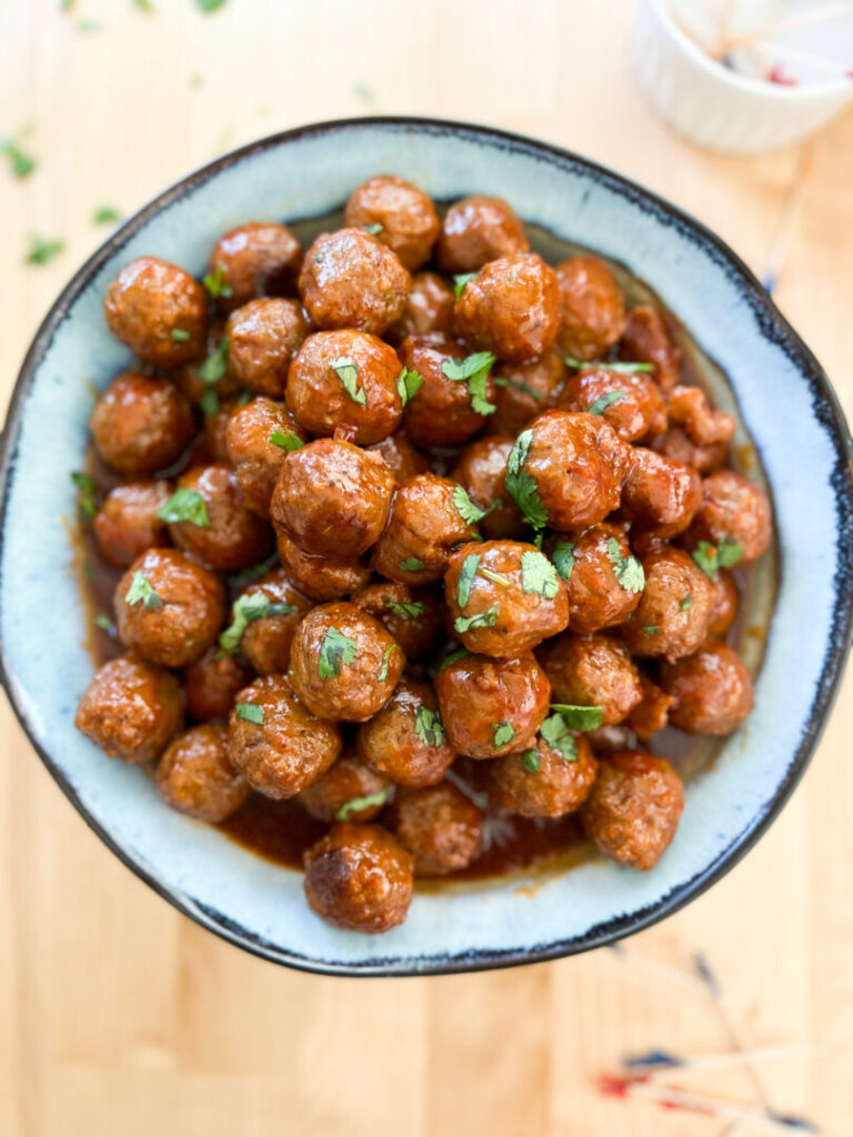 Instant Pot Grape Jelly Meatballs in a blue bowl.