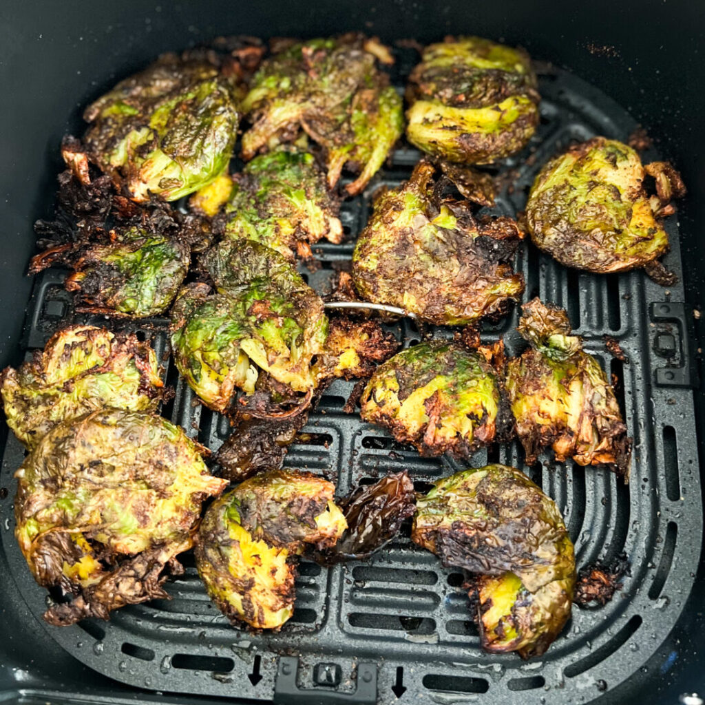 Cooked Air Fried Brussels Sprouts in air fryer basket.