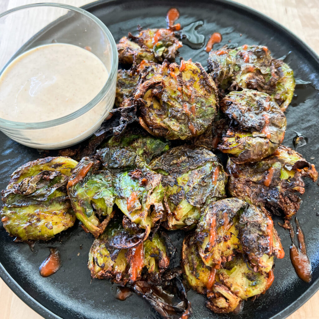 Air Fryer Brussels Sprouts on a black plate.